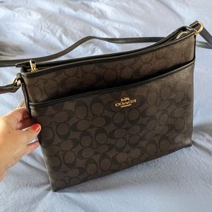 Espresso COACH bag with black trim, gold accents.